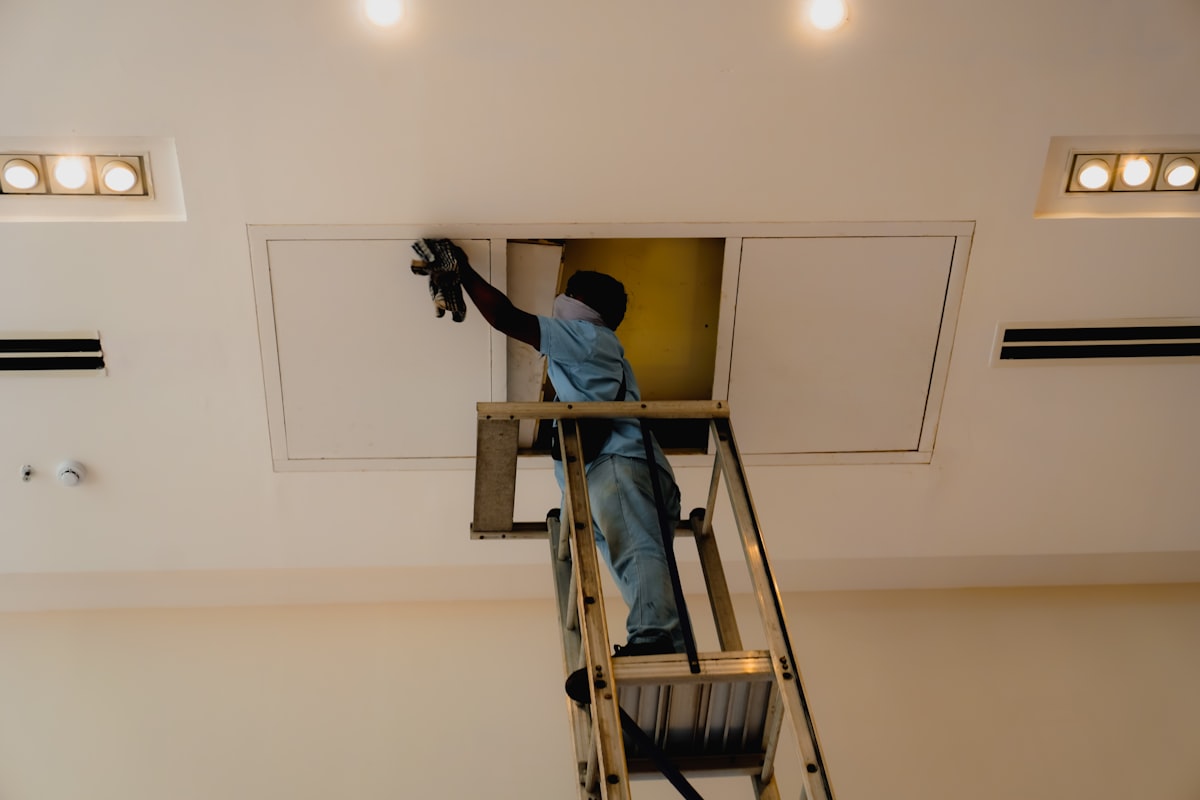 Technician installing an air conditioning system
